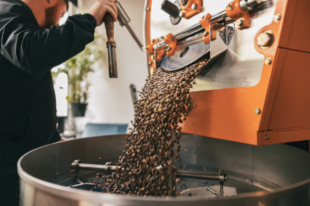 fresh-roasted-beans-falling-into-roaster-cooling-tray